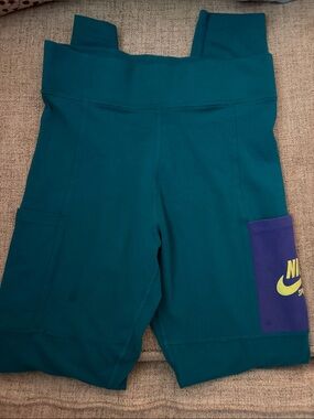 Nike Teal Workout Shorts with Purple Pocket and Yellow Logo